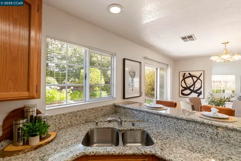 a dining room with furniture window and wooden floor