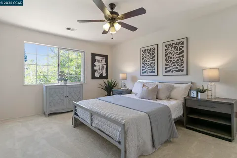 a bedroom with a large bed and a window