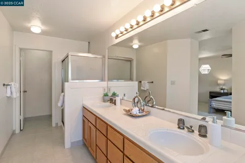 an empty room with a fan & a window