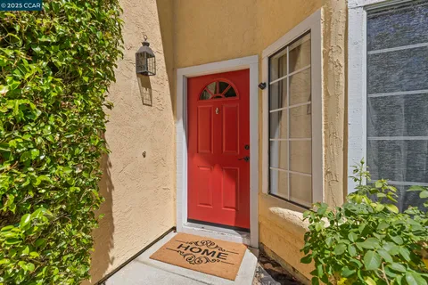 a living room with furniture a rug and a large window