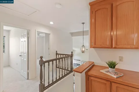 a view of a chair and table in backyard of the house