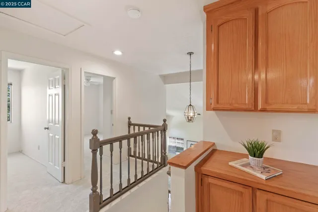 a view of a chair and table in backyard of the house