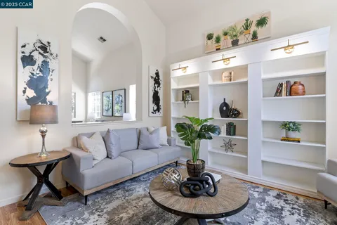 a living room with furniture potted plant and wooden floor