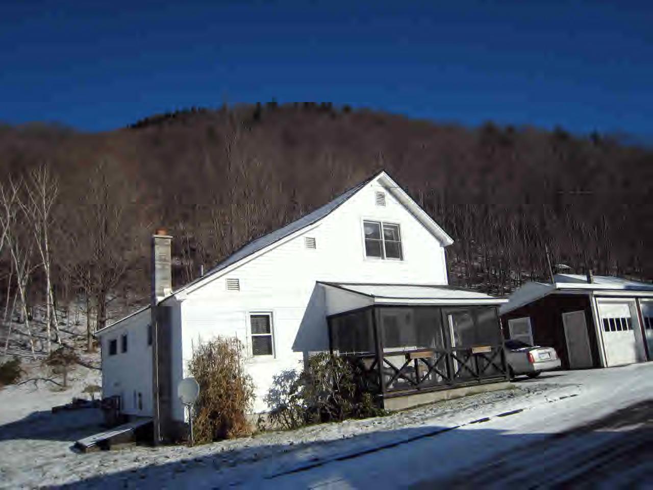 146 River Road Monroe, MA 01350 - Photo 2 of 8 a view of a white house next to a yard with large trees