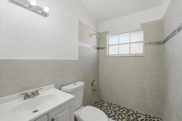 a bathroom with a sink toilet and shower