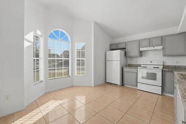 a kitchen with a stove a sink and a refrigerator