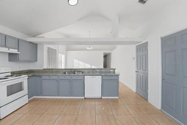 a large bathroom with a granite countertop sink and washing machine