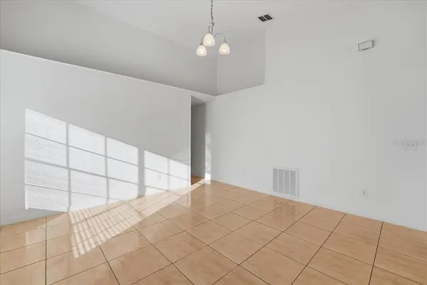a view of a livingroom with an empty space and a window