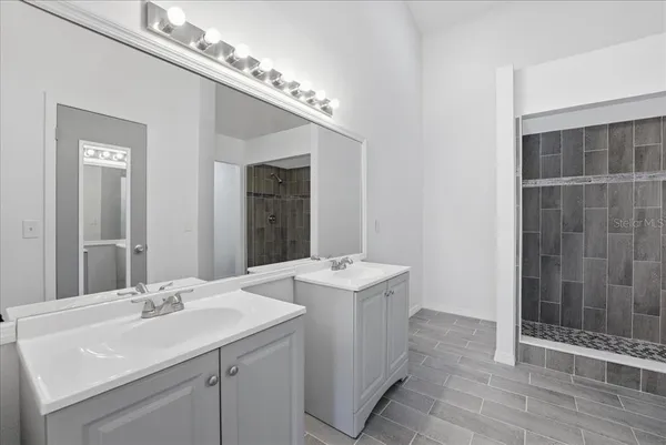 a bathroom with a sink double vanity and a mirror