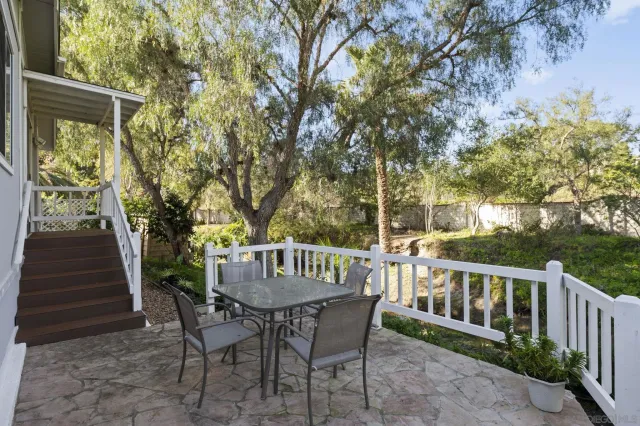 a view of a chairs and table in backyard