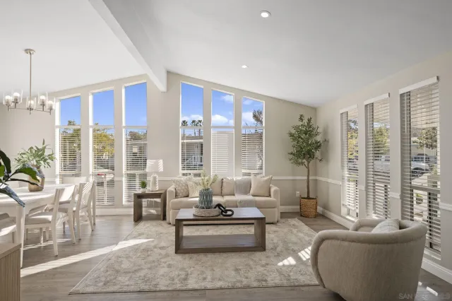 a living room with furniture and large windows