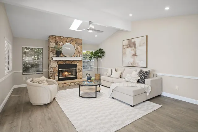 a living room with furniture and a fireplace