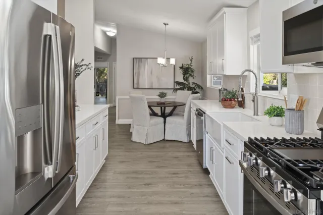 a kitchen with stainless steel appliances a sink stove and refrigerator