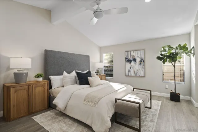 a bedroom with a bed and a potted plant