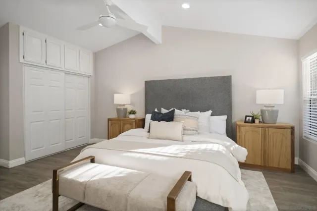 a bedroom with a bed and with furniture