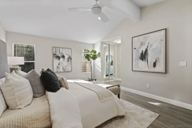 a bedroom with a bed and a painting on the wall