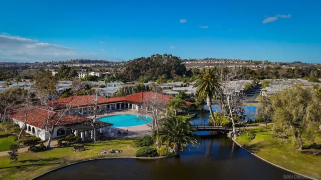 a view of a city with lots of residential buildings ocean and mountain view in back