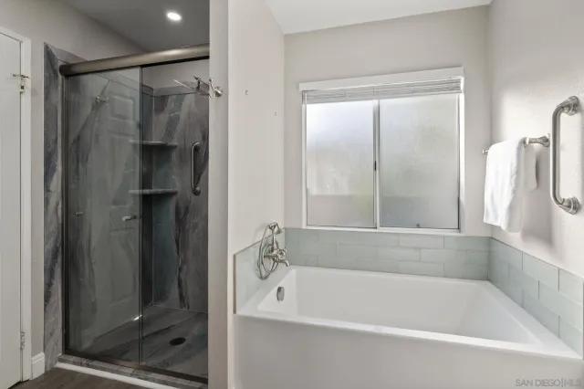 a white bath tub sitting next to a shower