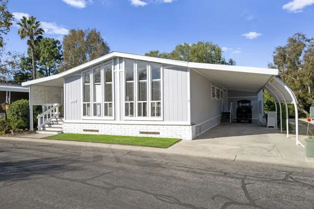 a view of a house with a swimming pool and a yard