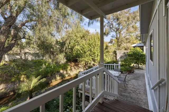 a view of a balcony with wooden fence
