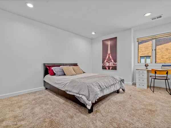 a spacious bedroom with a bed and window