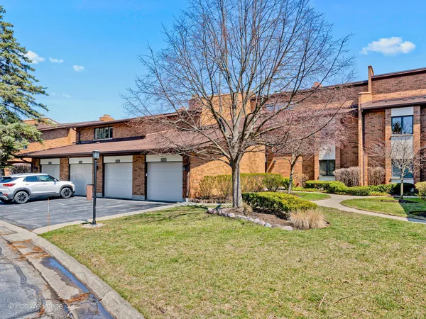 a view of a house with a yard and garage