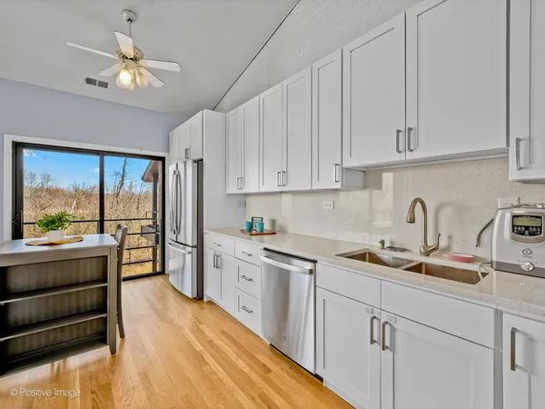 a kitchen with cabinets window and stainless steel appliances