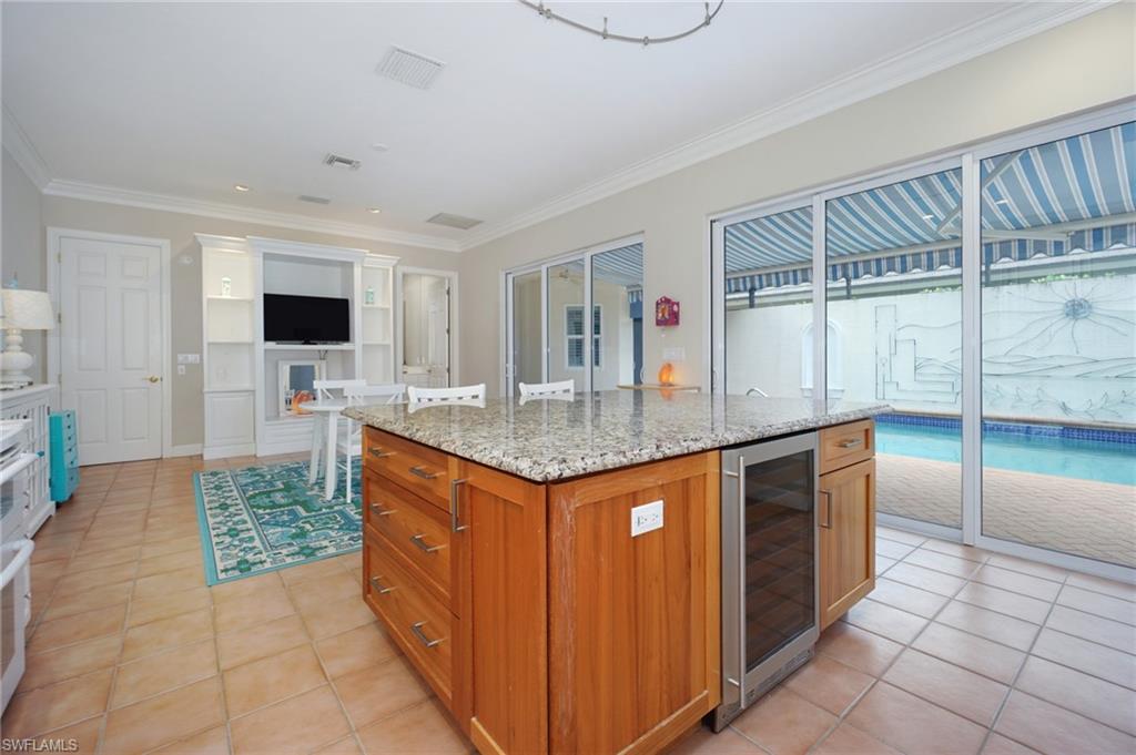 922 Turtle Court Naples, FL 34108 - Photo 11 of 29 a kitchen with granite countertop a sink and a stove top oven