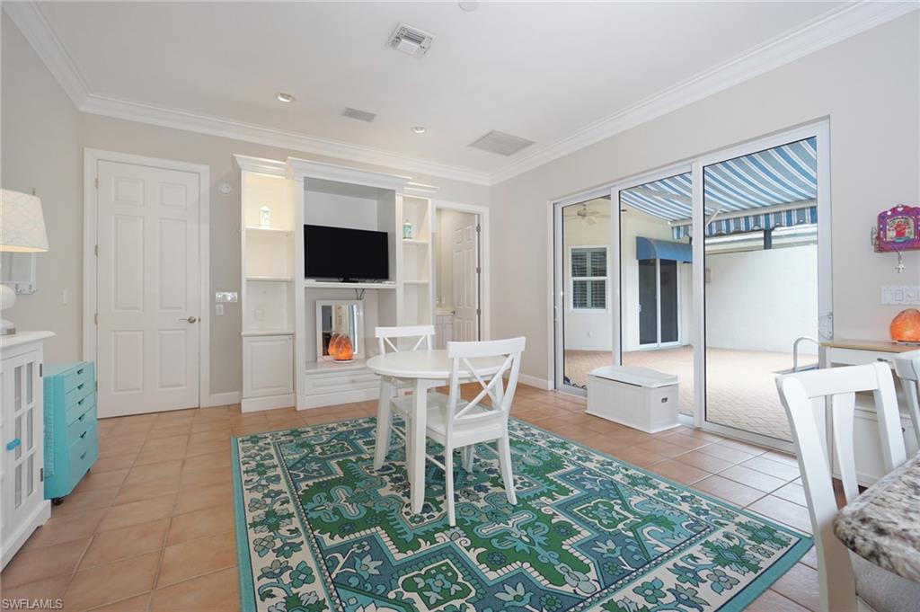 922 Turtle Court Naples, FL 34108 - Photo 12 of 29 a living room with a couch and a flat screen tv