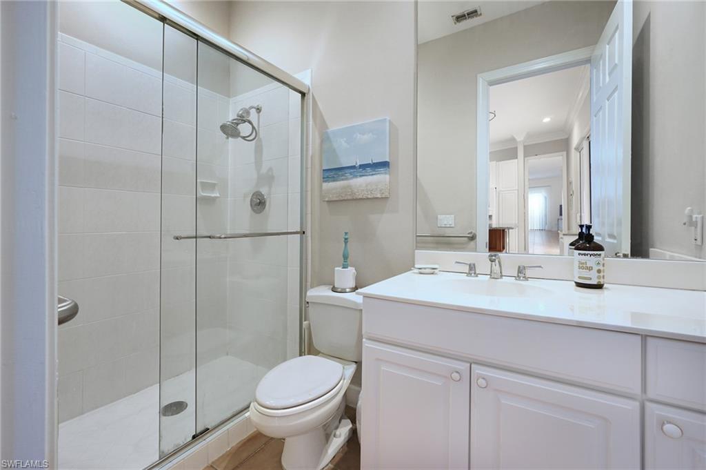 922 Turtle Court Naples, FL 34108 - Photo 14 of 29 a bathroom with a sink toilet and shower