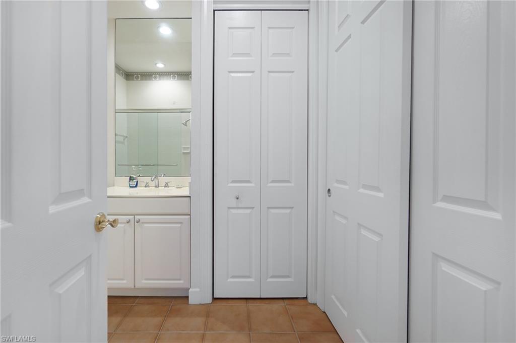 922 Turtle Court Naples, FL 34108 - Photo 25 of 29 a bathroom with a sink and mirror