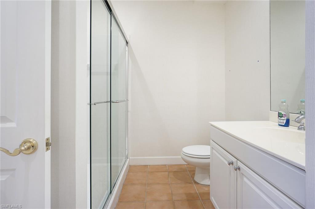 922 Turtle Court Naples, FL 34108 - Photo 26 of 29 a bathroom with a sink a toilet and a mirror