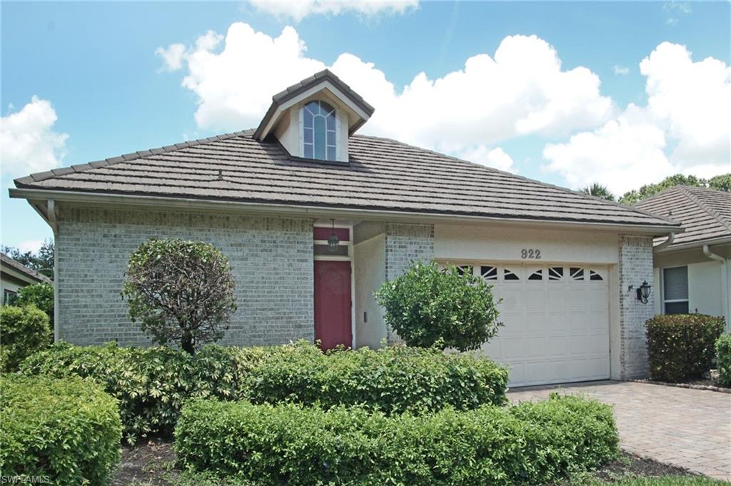 922 Turtle Court Naples, FL 34108 - Photo 3 of 29 a front view of a house with garden