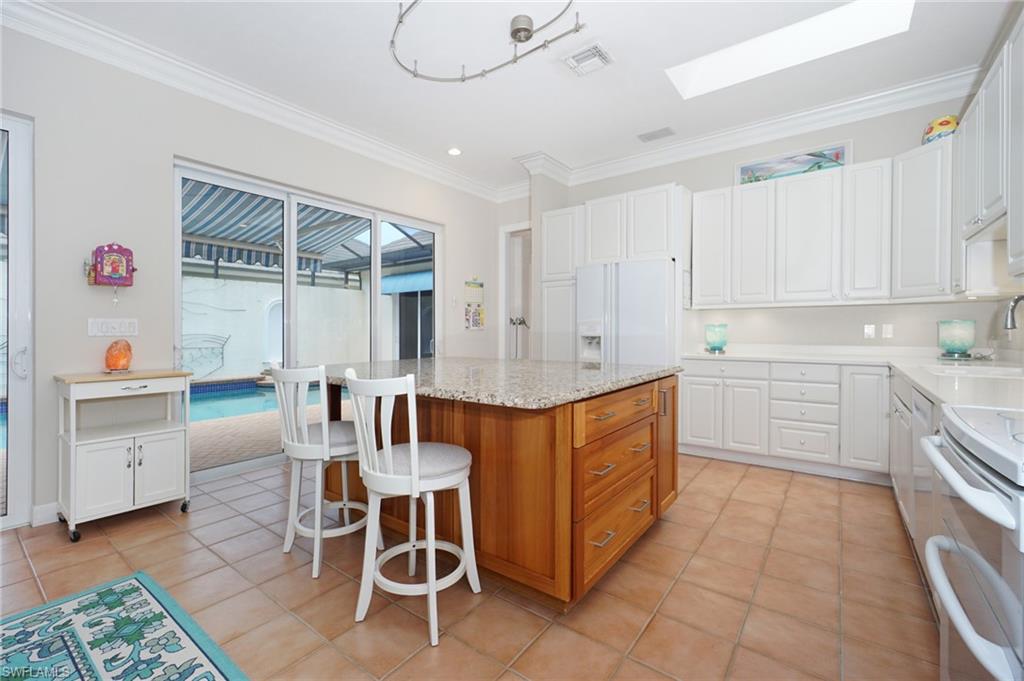 922 Turtle Court Naples, FL 34108 - Photo 9 of 29 a kitchen with a sink counter top space and appliances