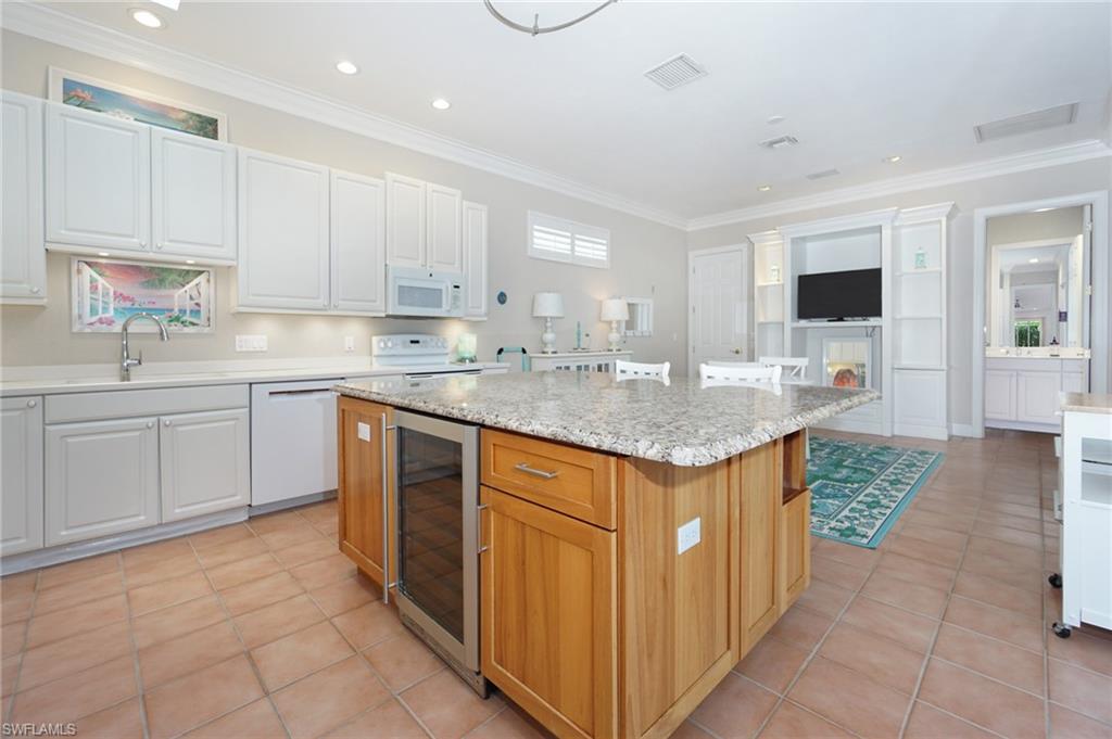 922 Turtle Court Naples, FL 34108 - Photo 10 of 29 a kitchen with stainless steel appliances granite countertop a sink and cabinets