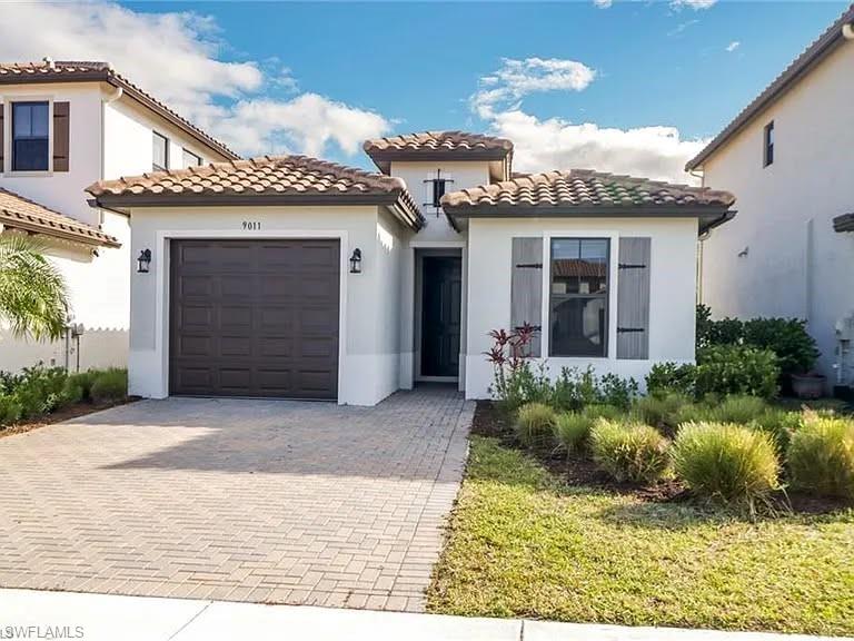 9011 Madrid Circle Naples, FL 34104 - Photo 1 of 20 a view of a house with a porch