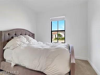 9011 Madrid Circle Naples, FL 34104 - Photo 11 of 20 a large white bed in a white room