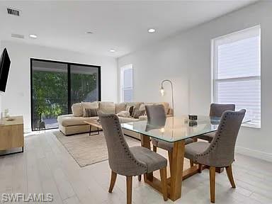 9011 Madrid Circle Naples, FL 34104 - Photo 13 of 20 a living room with furniture and a flat screen tv