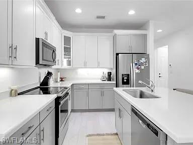 9011 Madrid Circle Naples, FL 34104 - Photo 14 of 20 a kitchen with granite countertop a sink stove and refrigerator