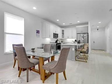 9011 Madrid Circle Naples, FL 34104 - Photo 19 of 20 a view of a dining room with furniture