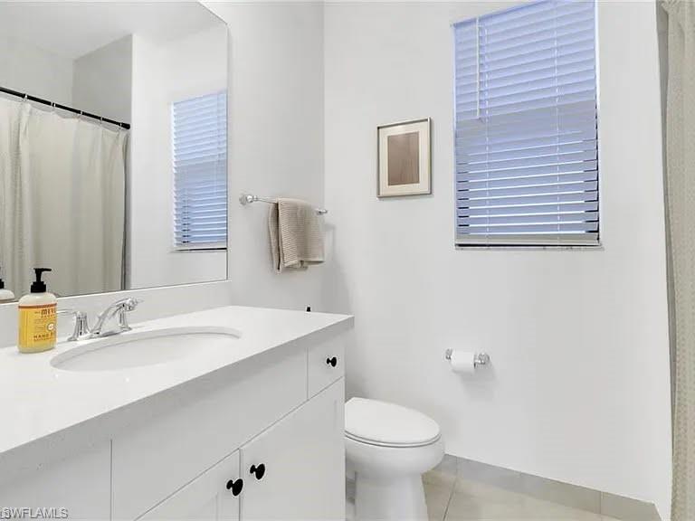 9011 Madrid Circle Naples, FL 34104 - Photo 3 of 20 a bathroom with a sink and a mirror