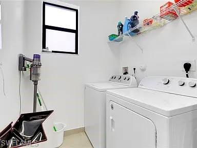 9011 Madrid Circle Naples, FL 34104 - Photo 5 of 20 a utility room with dryer and washer