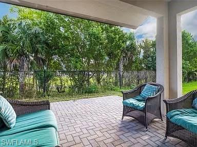 9011 Madrid Circle Naples, FL 34104 - Photo 9 of 20 a garden view with a seating space