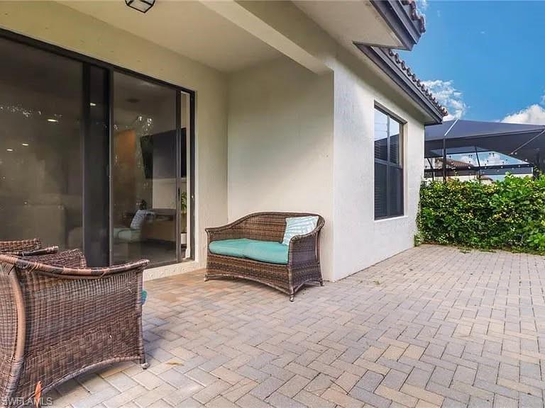 9011 Madrid Circle Naples, FL 34104 - Photo 10 of 20 a building outdoor space with patio furniture