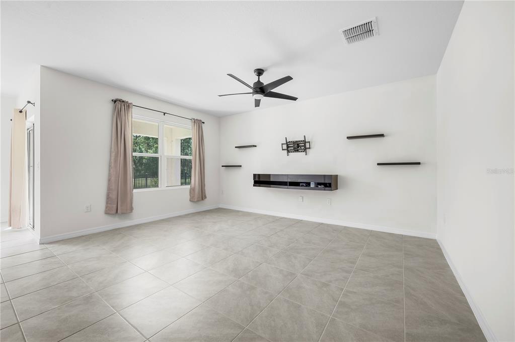 114 Birch Tree Place Daytona Beach, FL 32117 - Photo 11 of 33 an empty room with ceiling fan and window