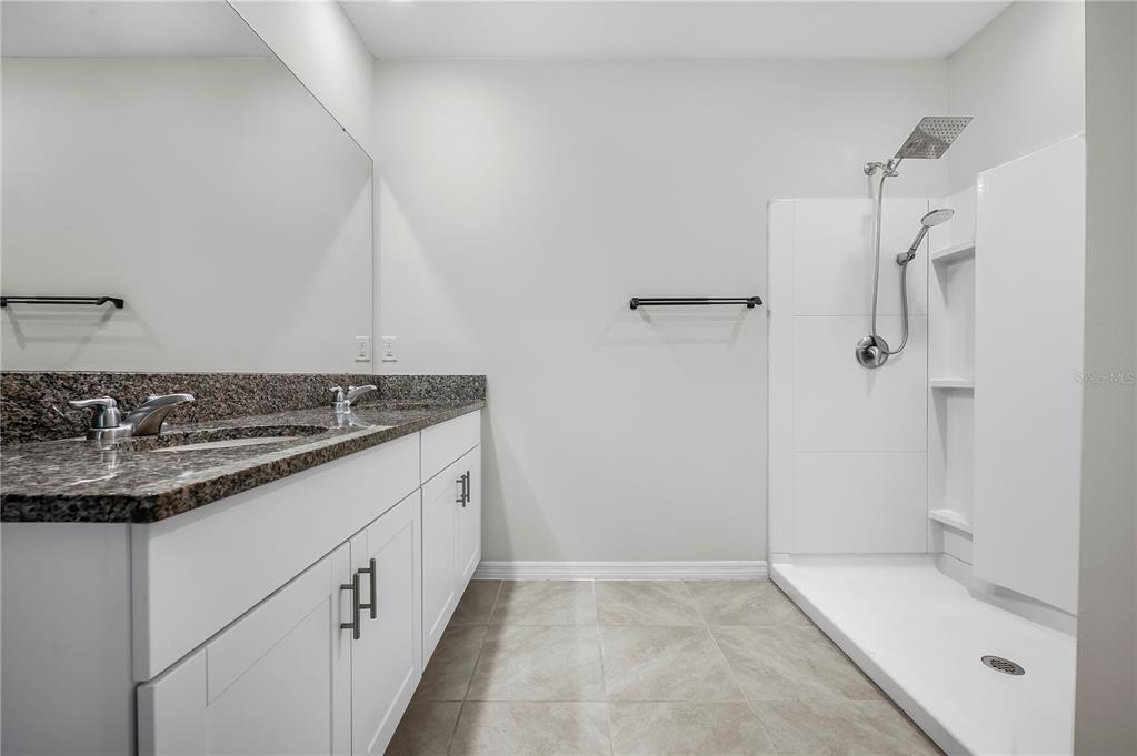 114 Birch Tree Place Daytona Beach, FL 32117 - Photo 19 of 33 a bathroom with a granite countertop sink a toilet and shower