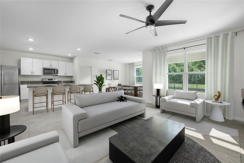 114 Birch Tree Place Daytona Beach, FL 32117 - Photo 2 of 33 a living room with furniture and a large window with kitchen view