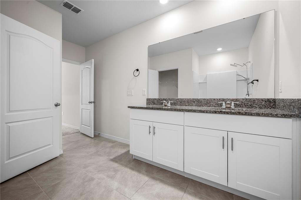114 Birch Tree Place Daytona Beach, FL 32117 - Photo 21 of 33 a spacious bathroom with a granite countertop sink and a mirror