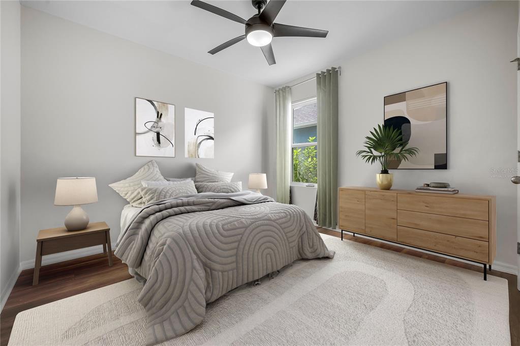 114 Birch Tree Place Daytona Beach, FL 32117 - Photo 22 of 33 a bedroom with a bed and a chandelier