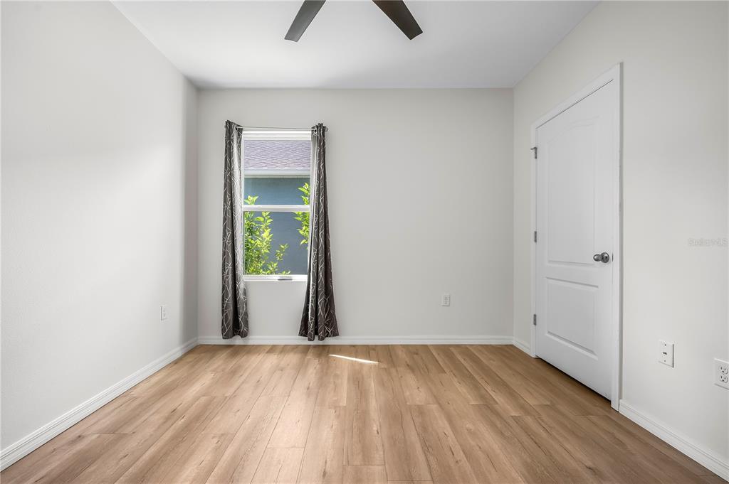 114 Birch Tree Place Daytona Beach, FL 32117 - Photo 23 of 33 a view of an empty room with wooden floor and a window